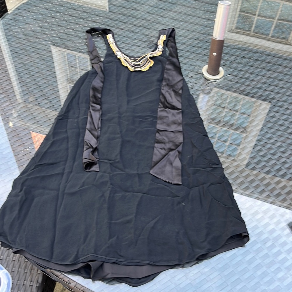 Black lined Alice and Olivia halter dress with gold details and a scooped back.